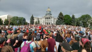 crowd gathered at base of colorado capitol