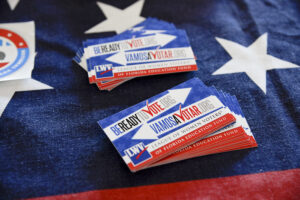 stack of register to vote cards laid on an American flag
