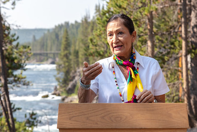 Secty Halland speaking in front of a river