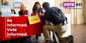be informed vote informed; people at voter registration table