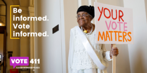 older woman holding sign saying your vote matters